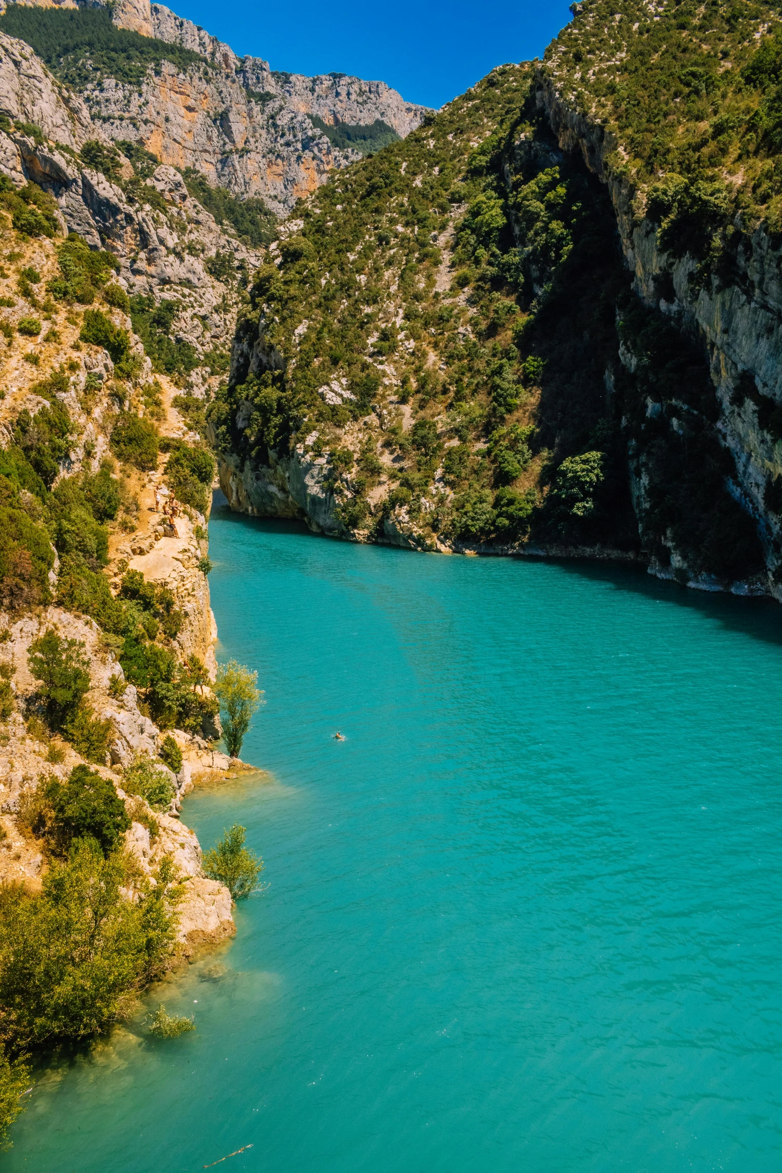 a large body of water surrounded by mountains, les nabis, nice deep colours, canyons, touring, quaint