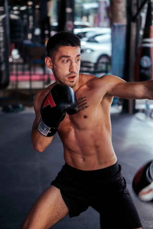 a young man with boxing gloves on