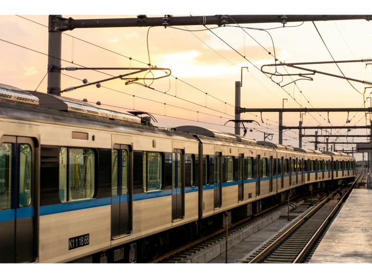 a large long train on a steel track, unsplash, sōsaku hanga, square, late afternoon lighting, 2022 photograph, subways