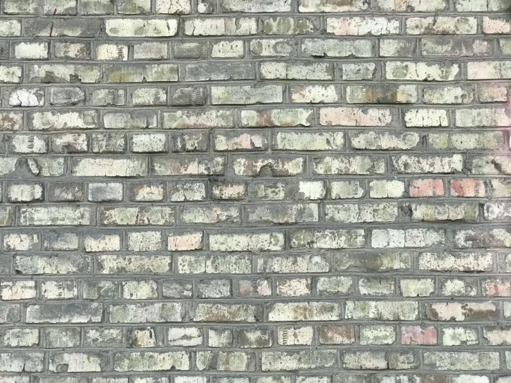 an old brick wall with peeling paint and chipped paint