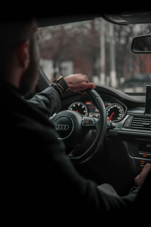 a man sitting in the driver's seat of a car, pexels contest winner, a man wearing a black jacket, promo image, whip in hand, square