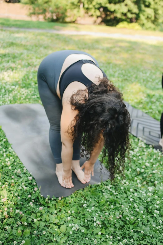 a woman bent over on a mat doing yoga