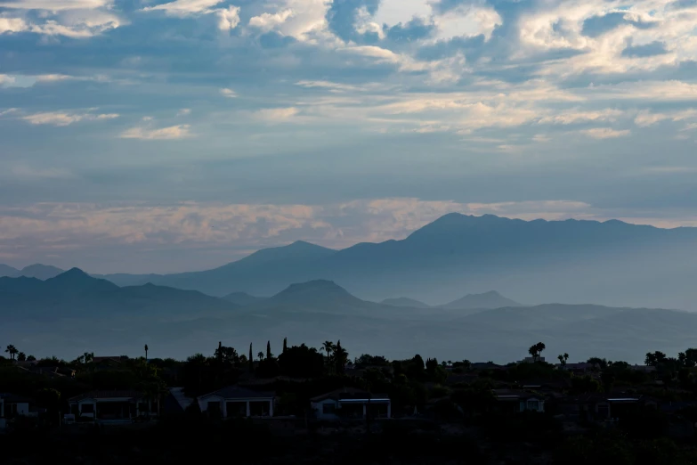 a view of mountains with houses and mountains in the background