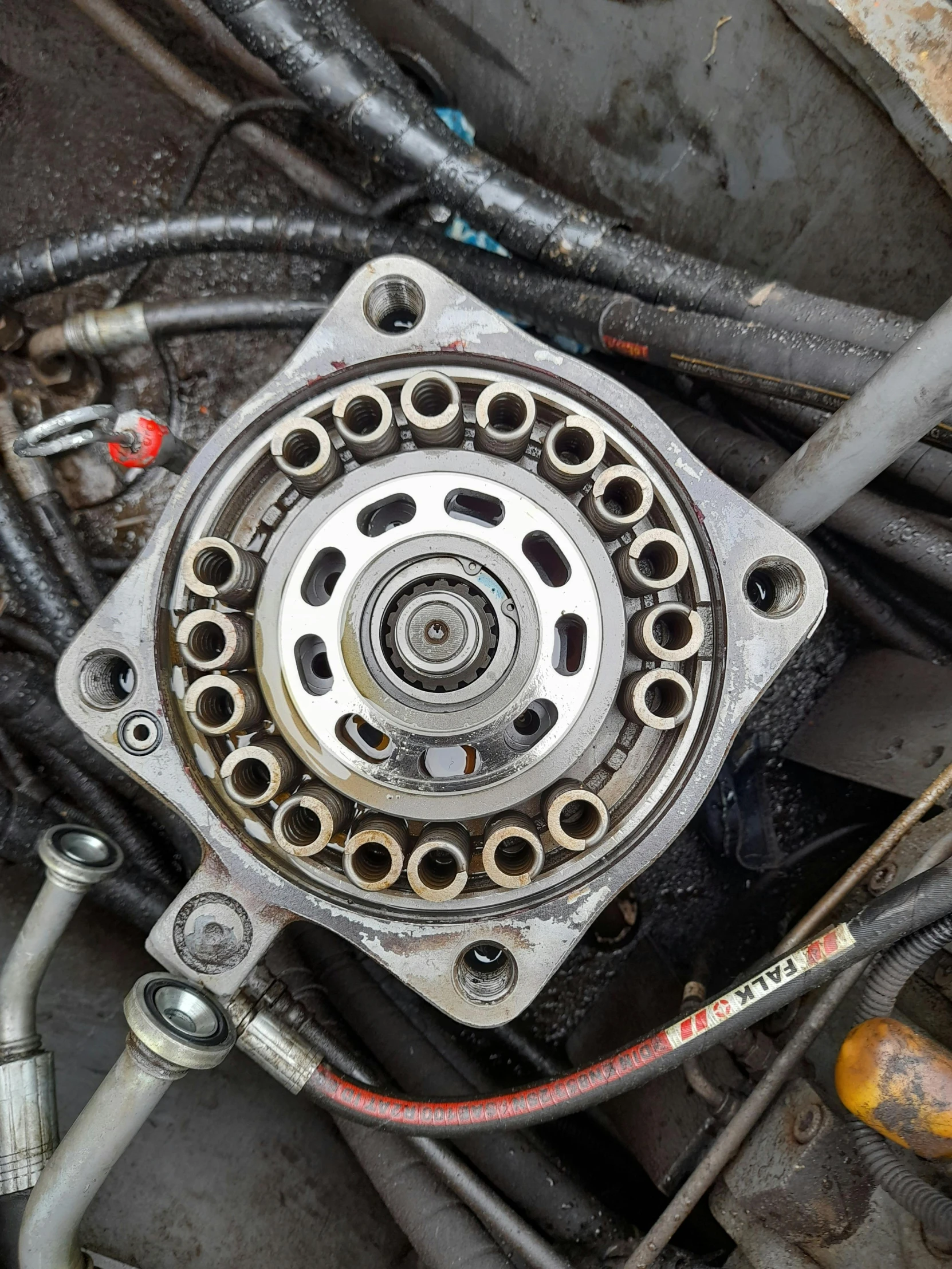 a close up of a motor and wires, a picture, reddit, leaking oil, inner ring, bearing a large mad grin, spiralling