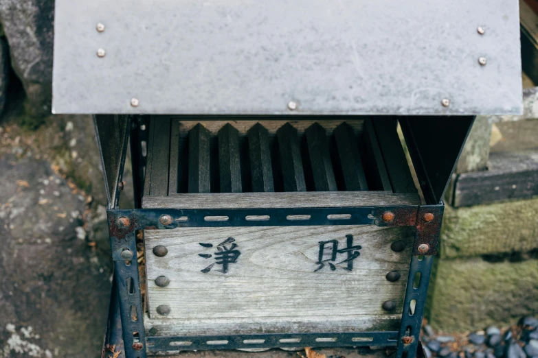 a metal box with writing on it sitting outside