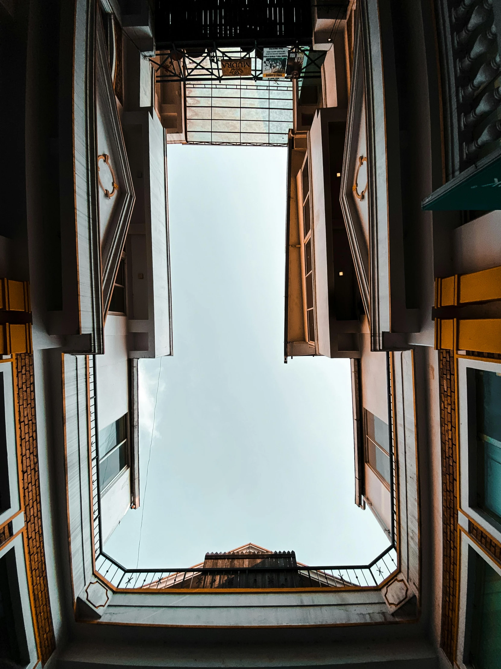 looking down into an empty room with windows and a few steps