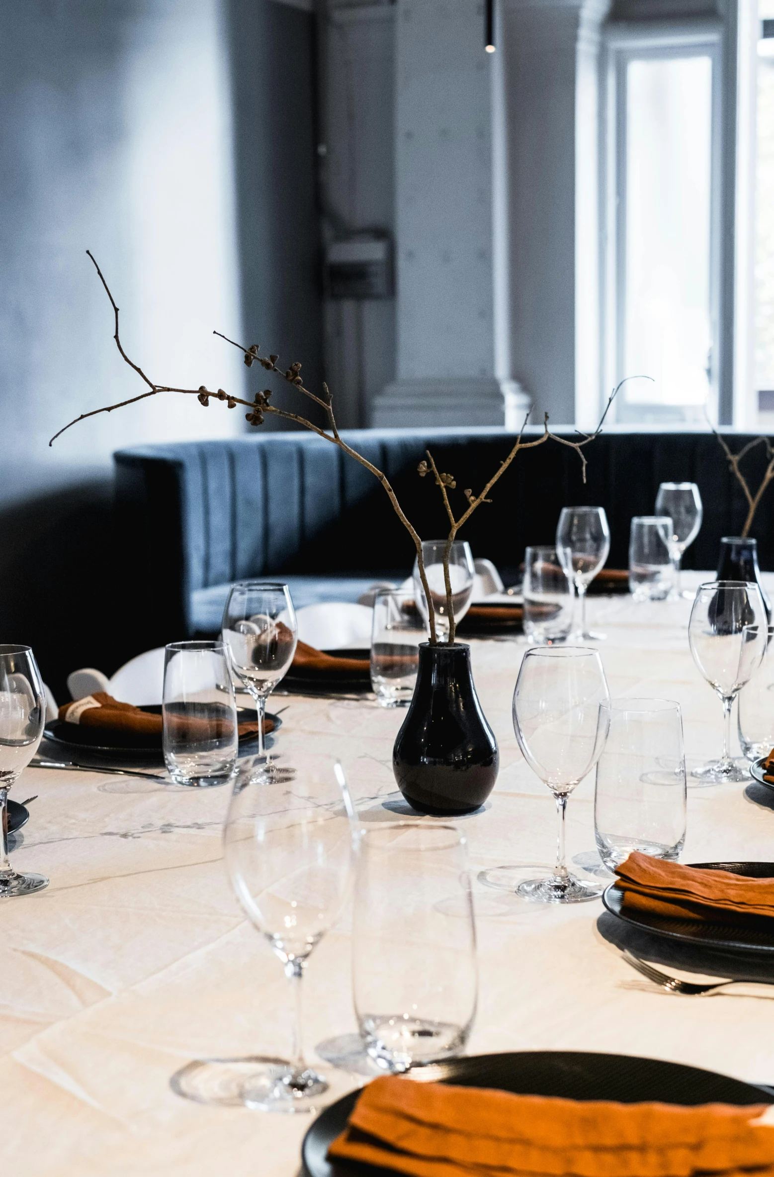 a white table with a lot of glasses and place settings on it