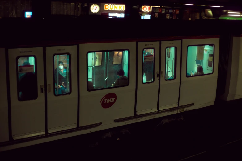 a subway train pulling into a station at night, by Elsa Bleda, 90s photo, fan favorite, aquamarine windows, distant glowing figures