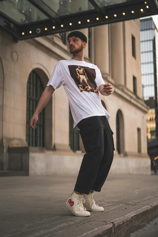 a man riding a skateboard down the side of a street, a picture, trending on pexels, renaissance, printed on a cream linen t-shirt, posing like a statue, wearing cargo pants, tom of finland style