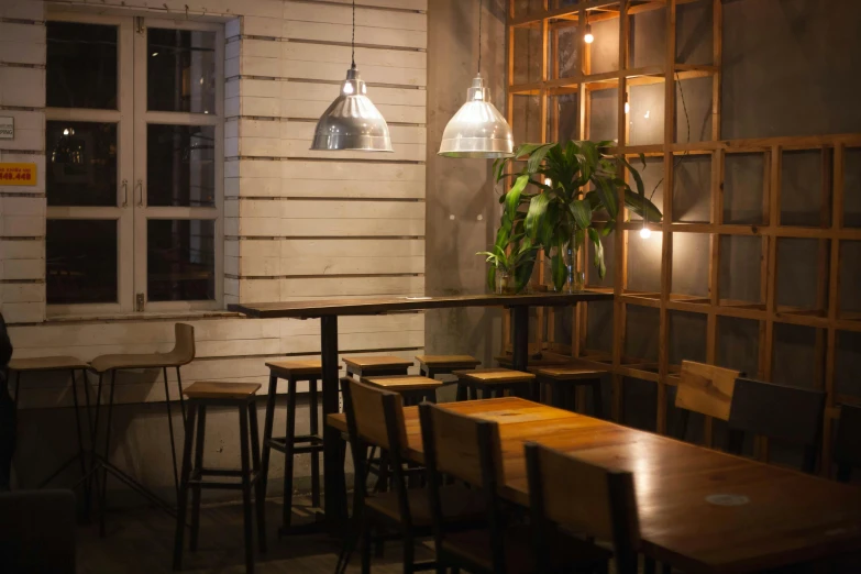 a room with several tables and chairs and lights