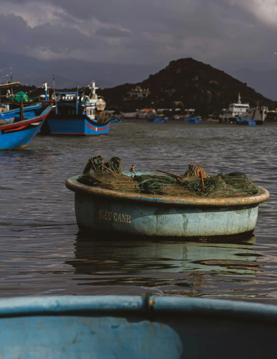 a group of boats floating on top of a body of water, a picture, unsplash contest winner, process art, fisherman's hat, crab, vietnam, album cover