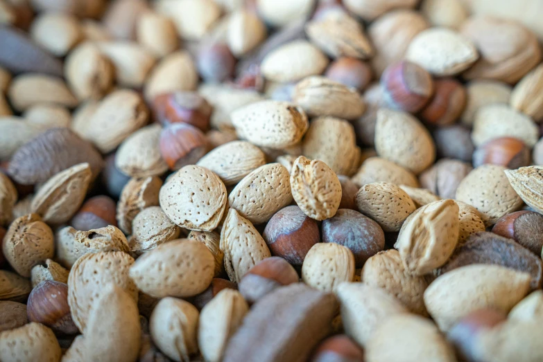 a pile of nuts sitting on top of a table, by Daniel Lieske, trending on pexels, fan favorite, bottom body close up, 1 6 x 1 6, hemp