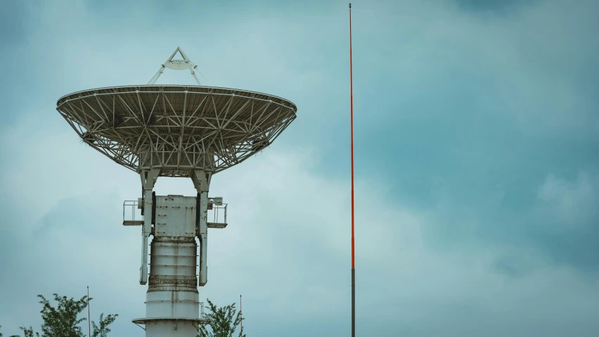 a satellite dish sitting on top of a metal pole, by Adam Marczyński, unsplash, renaissance, vintage color, futuristic tower, maintenance photo