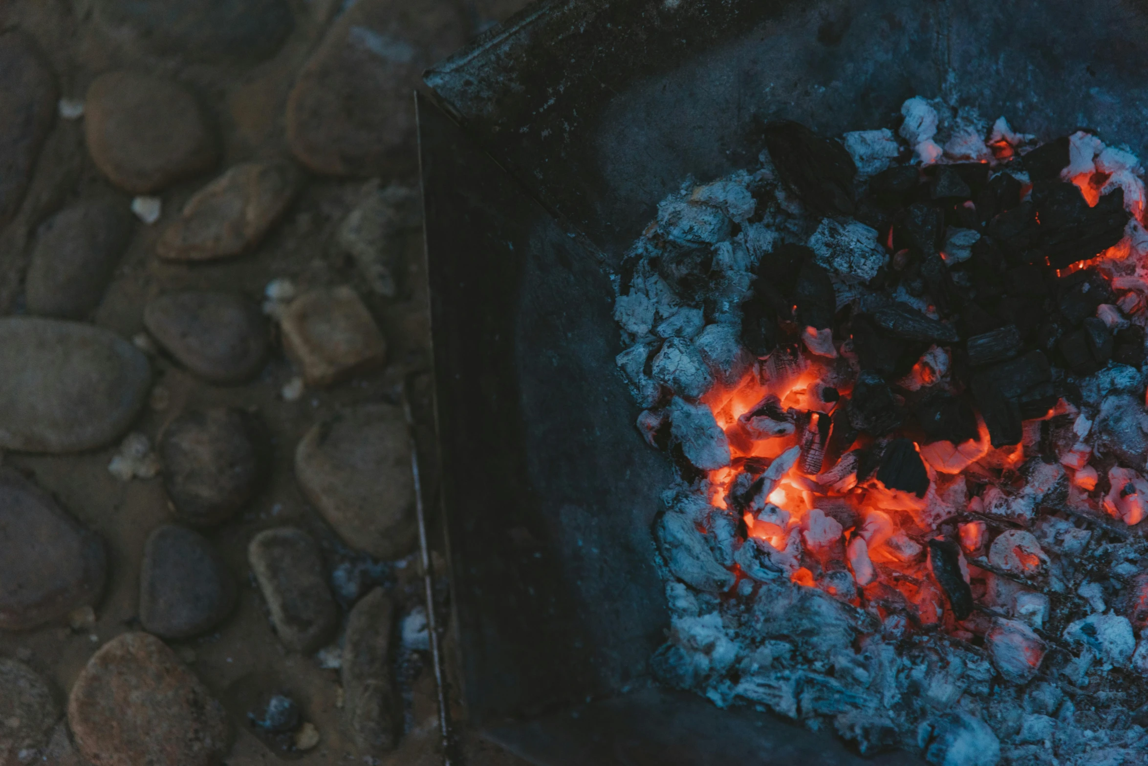 a coal stove that has red and black flames in it