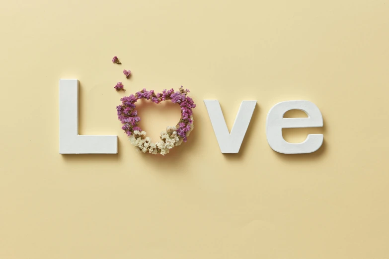 the word love with flowers in the shape of a heart, inspired by Louis Hersent, medium level shot, pale yellow wallpaper, studio product shot, advert