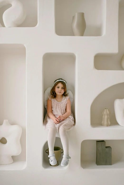a little girl that is sitting on a shelf, a marble sculpture, inspired by Isamu Noguchi, fairy palace, white gallery, wearing a light grey crown, ignant