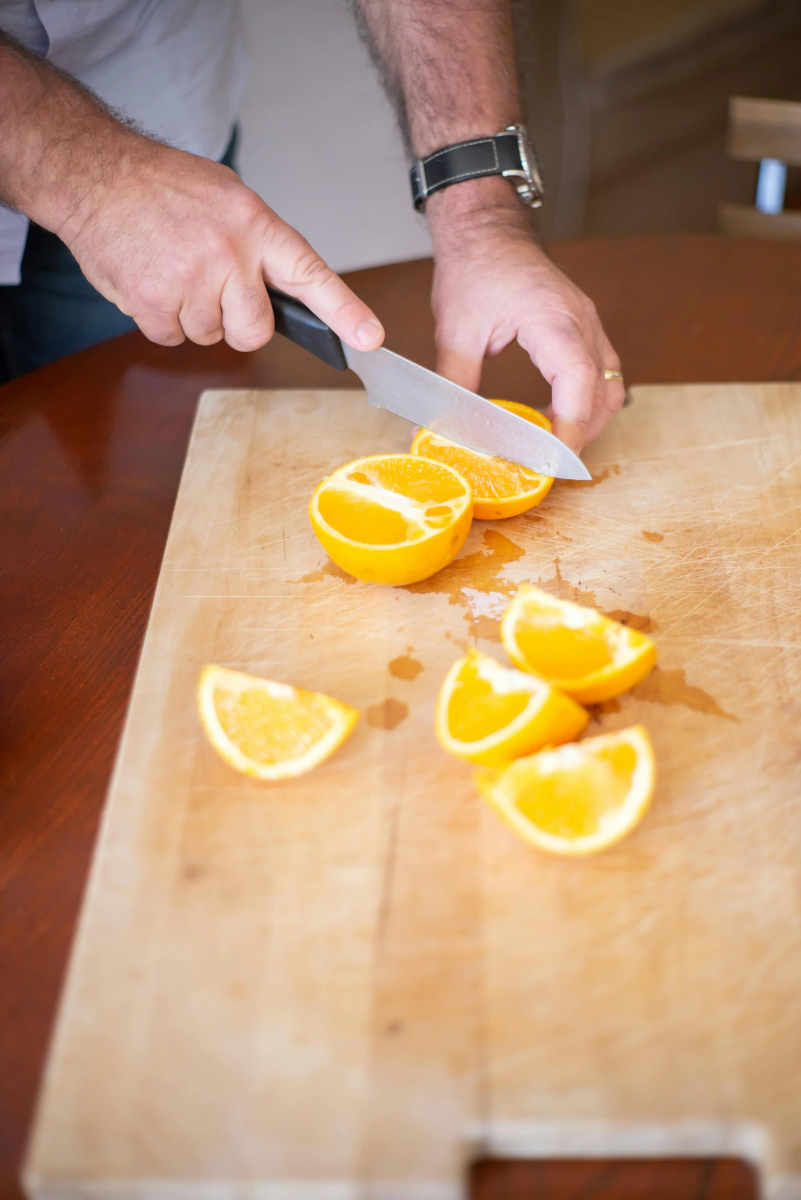 a man is cutting oranges on a cutting board, less detailing, uncrop, amanda lilleston, extra sharp