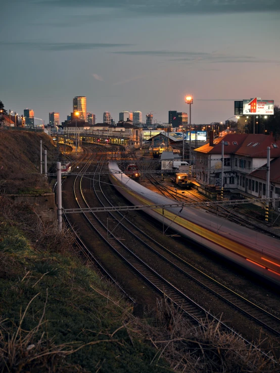 a long train traveling through a city at night