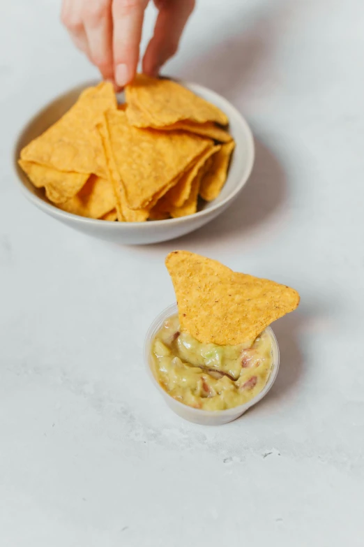 a white bowl filled with salsa and chips