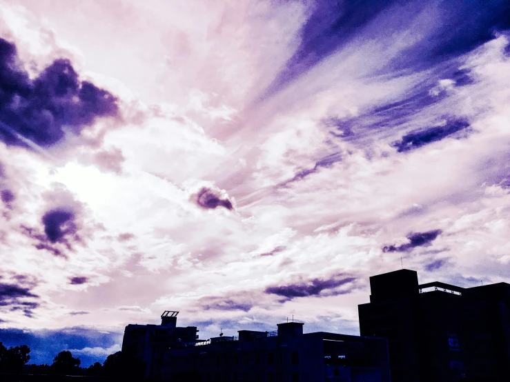 a person is flying a kite on a cloudy day, an album cover, by Sengai, unsplash, aestheticism, purple future city, alcohol with blue delirium skies, crepuscular!!, city views