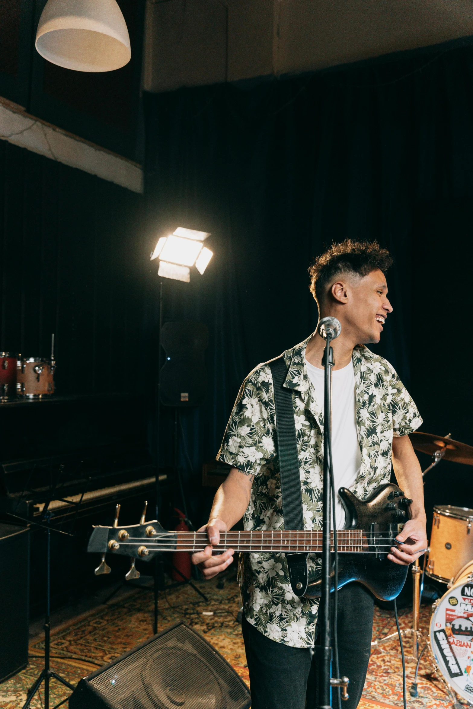 a man that is standing in front of a guitar, unsplash, photorealism, asian male, concert footage, slightly tanned, bassist