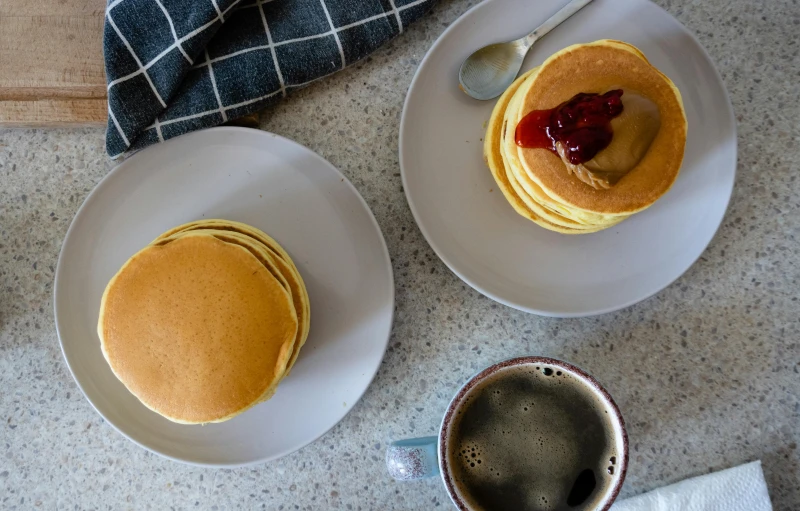 a close up of three plates with pancakes on them