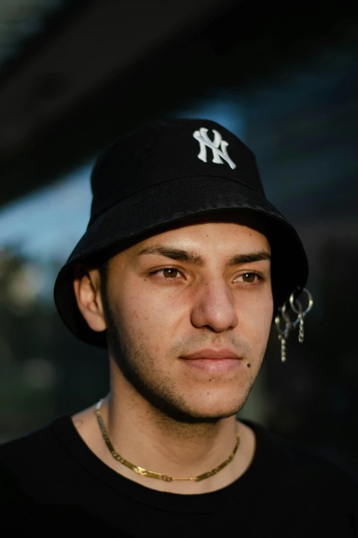 a close up of a person wearing a hat, reddit, hurufiyya, portrait of danny gonzalez, young male, taken in 2 0 2 0, low quality photo