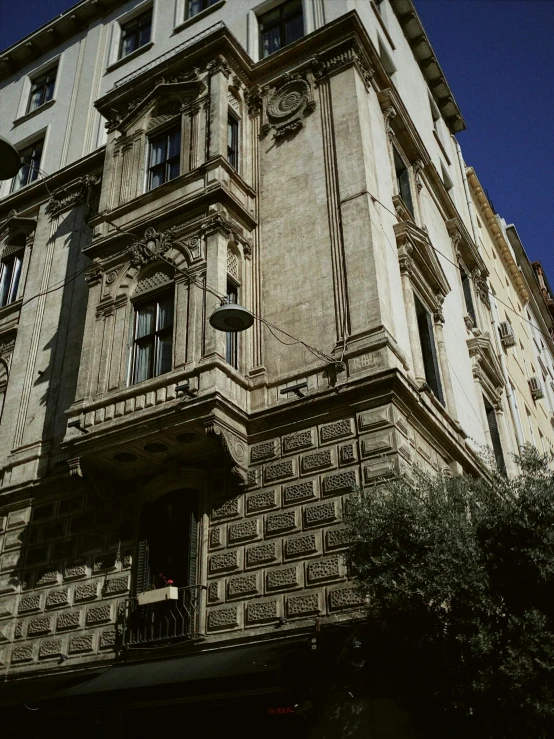 a tall building with a clock on the side of it, inspired by Gianfredo Camesi, neoclassicism, view from the street, 1999 photograph, rome, high detail photograph