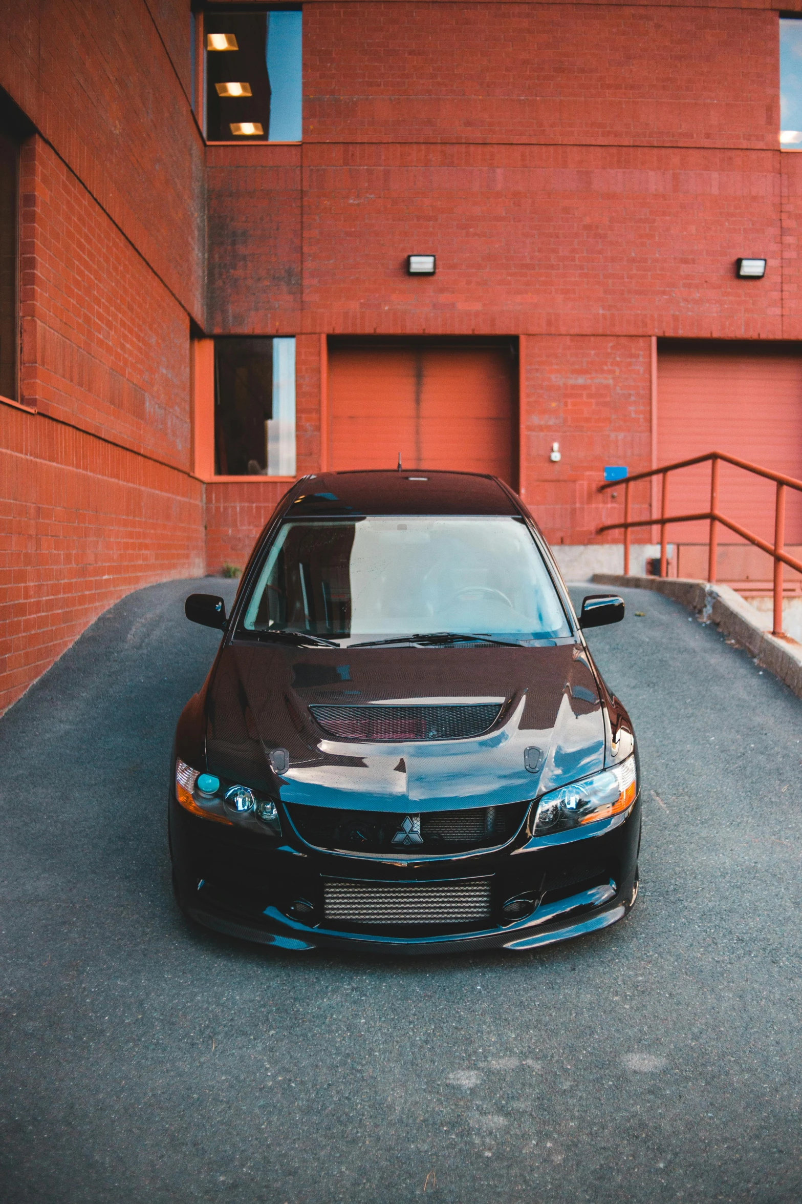 a car parked in front of a brick building, by Matthew Smith, pexels contest winner, samurai vinyl wrap, black roof, front portrait, 15081959 21121991 01012000 4k