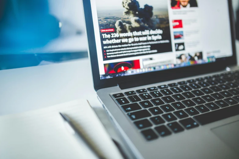 a laptop computer sitting on top of a desk, pexels, private press, news feed, realistic », 9 9 designs, middle close up