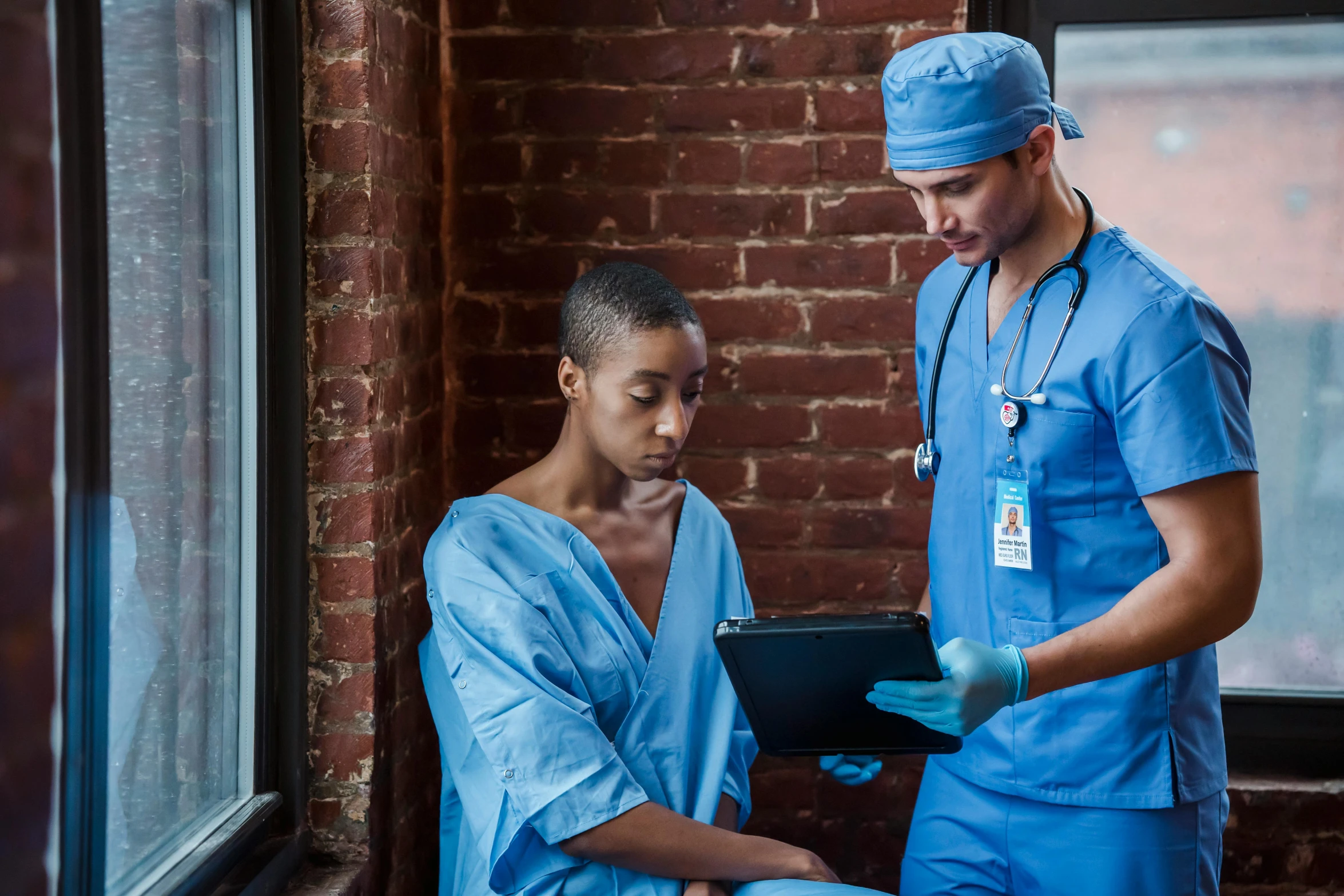 a couple of men standing next to each other, by Meredith Dillman, pexels, renaissance, nurse scrubs, sad prisoner holding ipad, ashteroth, surgical gown and scrubs on