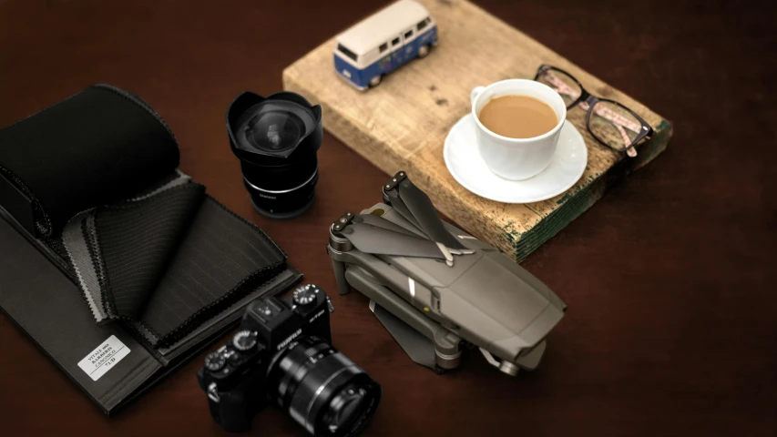 three items including camera, film and a bottle of coffee