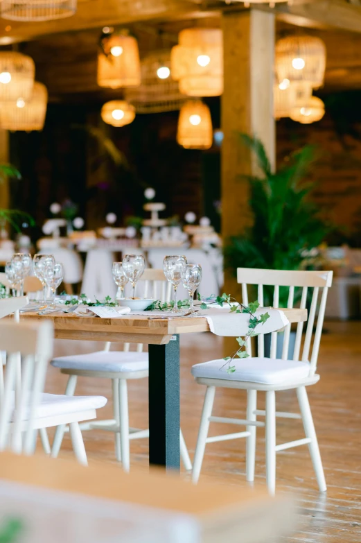 a long table is set up with white chairs