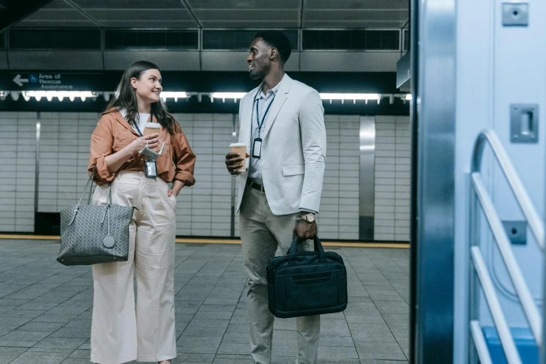 a man and a woman standing next to each other, by Carey Morris, pexels contest winner, holding a briefcase, subway station, office clothes, ad image