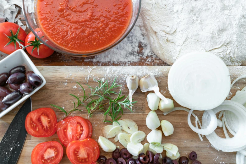 a cutting board topped with tomatoes, onions and olives, inspired by Géza Dósa, pexels, wings made of pizza, soup, thumbnail, cinematic still