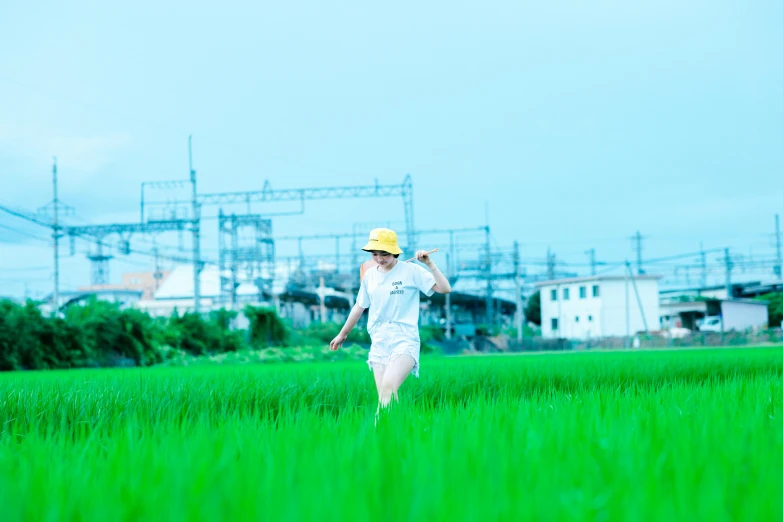 a woman walking across a lush green field, by Katsukawa Shun'ei, unsplash, happening, construction, hyper color photograph, white, power pose