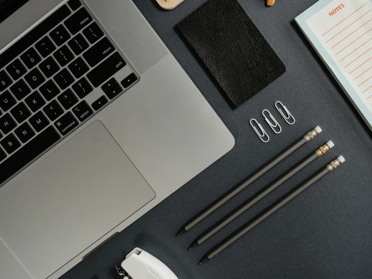 an open laptop computer sitting on top of a desk, trending on pexels, knolling, background image, 9 9 designs, grey and dark theme