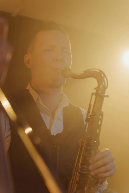 a man playing a saxophone on stage at night