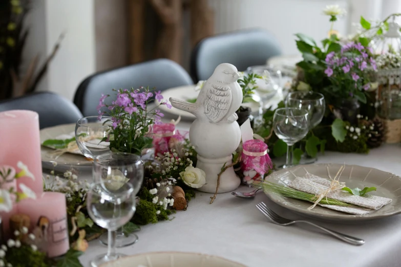 a table decorated with plates and place settings