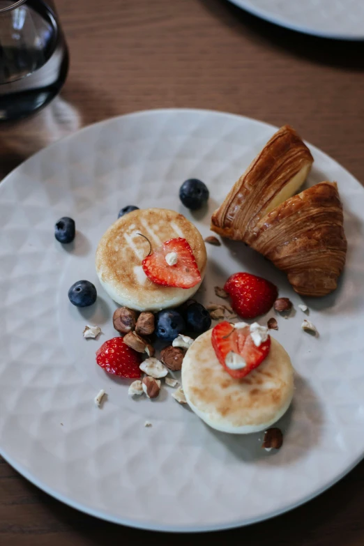 this is a plate with croissants and berries on it