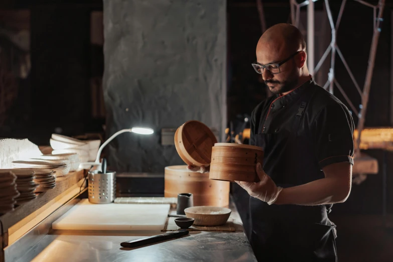 a man standing in a kitchen preparing food, wooden bowl, an award winning masterpiece, profile image, fan favorite