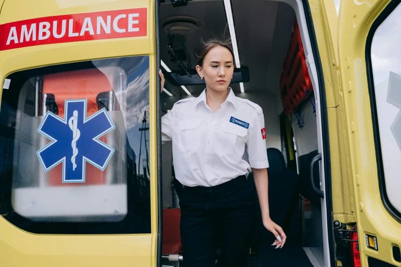 a woman standing in the doorway of an ambulance, trending on pexels, cai xukun, lachlan bailey, avatar image, uniform