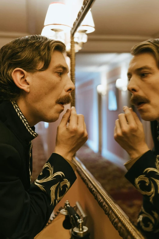 two men are standing next to a mirror brushing their teeth