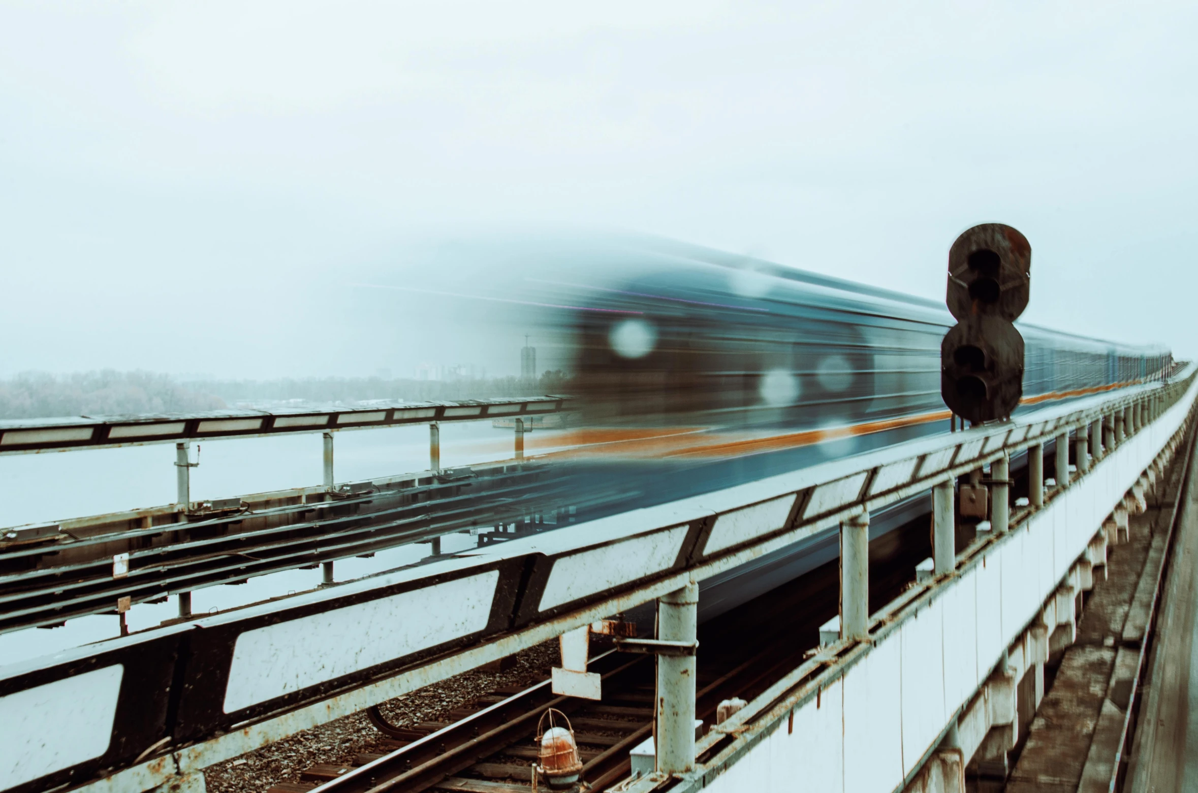 a train moving down the tracks on a bridge