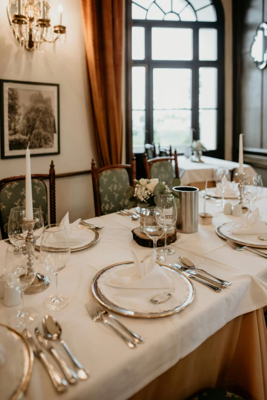 an empty table is set with silverware and flowers