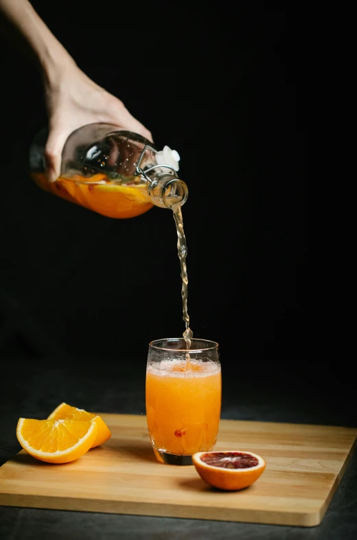 a person pouring orange juice into a glass, inspired by Jacopo Bellini, pexels, renaissance, with a black background, on a gray background, bubbly, mid-twenties