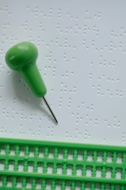 a close up of a plastic on on a green piece of plastic