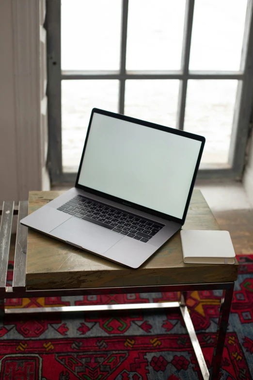 a laptop computer sitting on top of a wooden table, by Carey Morris, square, grey, universal