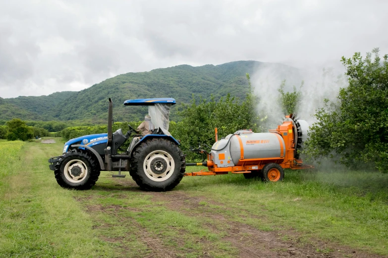 a tractor that is sitting in the grass, sprays, fruit trees, lerapi, 8 l