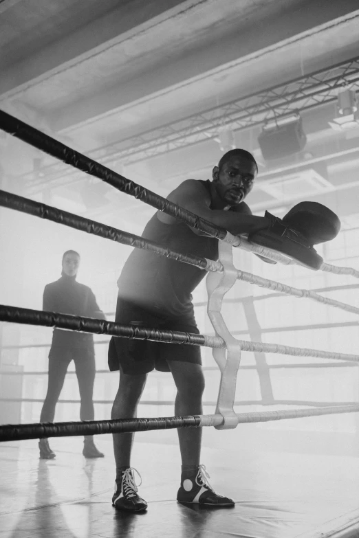 a black and white photo of a man in a boxing ring, inspired by Gordon Parks, pexels contest winner, emerging from the mist, ffffound, netting, music video